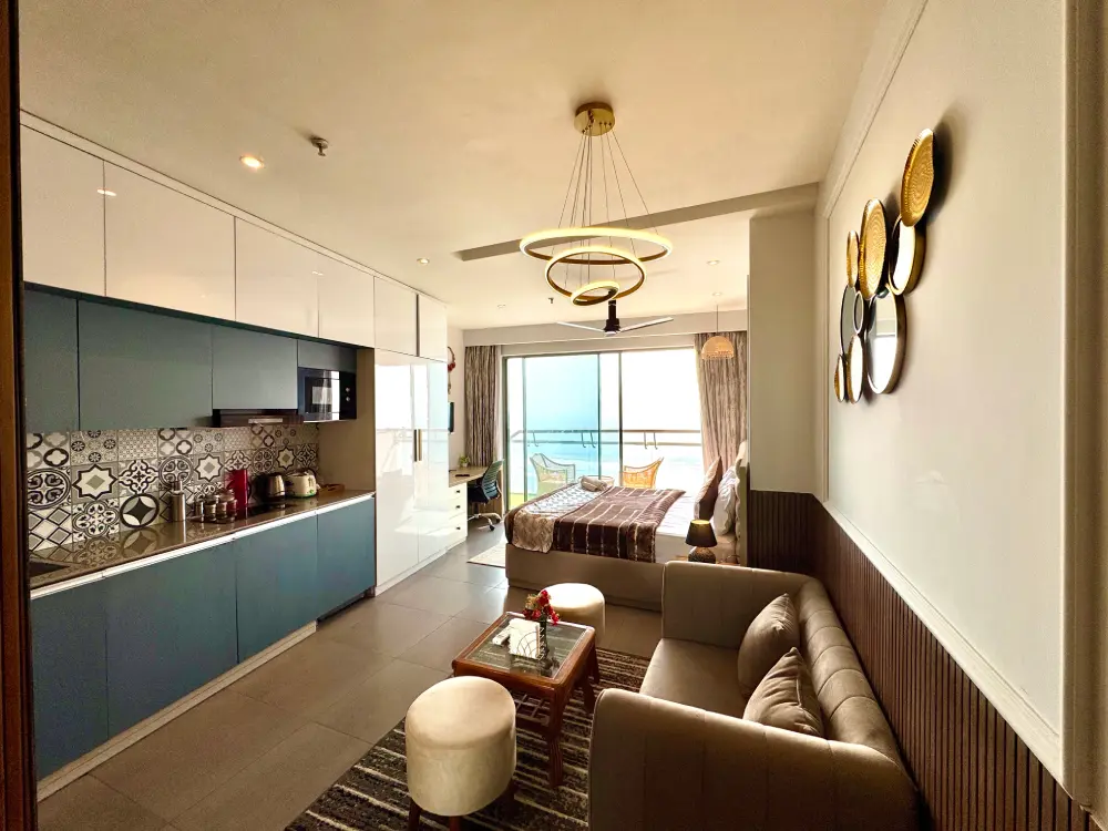 Eleve 31 open modular kitchen with navy blue lower cabinets and integrated hob unit