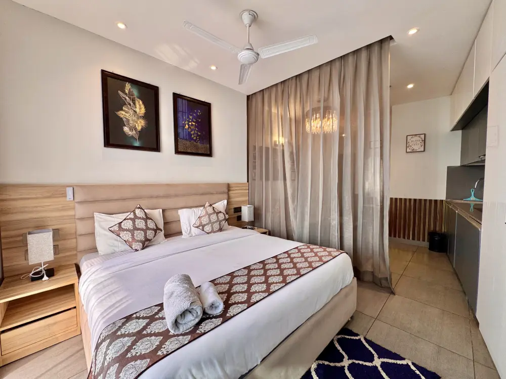 Supernova Spira stay bright white bedroom at luxury apartment Noida