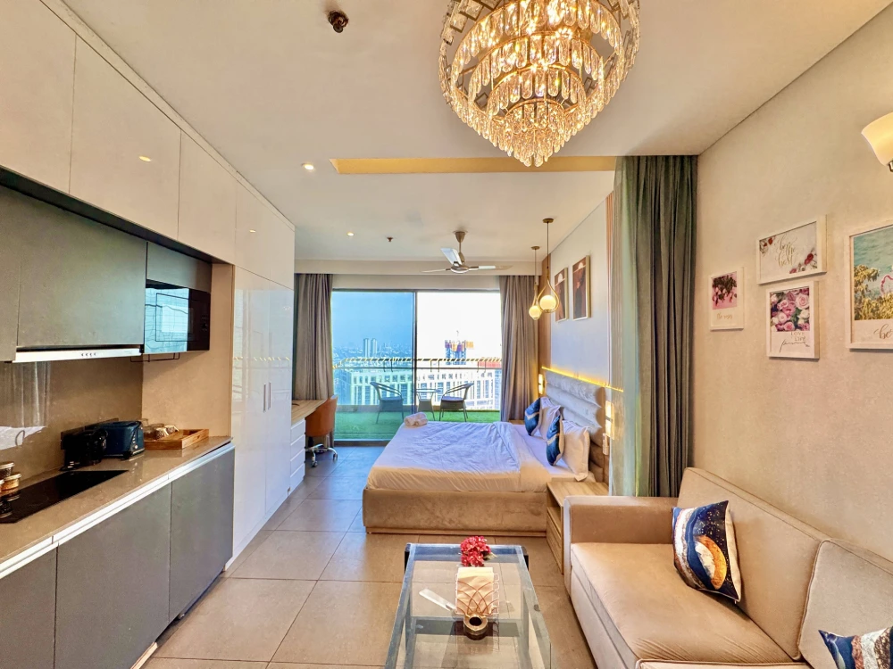 Cozy living room in high-rise apartment at Mulberry Homes Noida