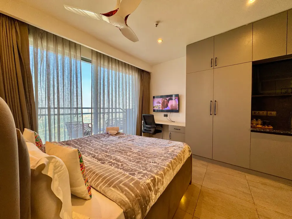 Modern bedroom with river window at Panorama 32 Supernova Noida